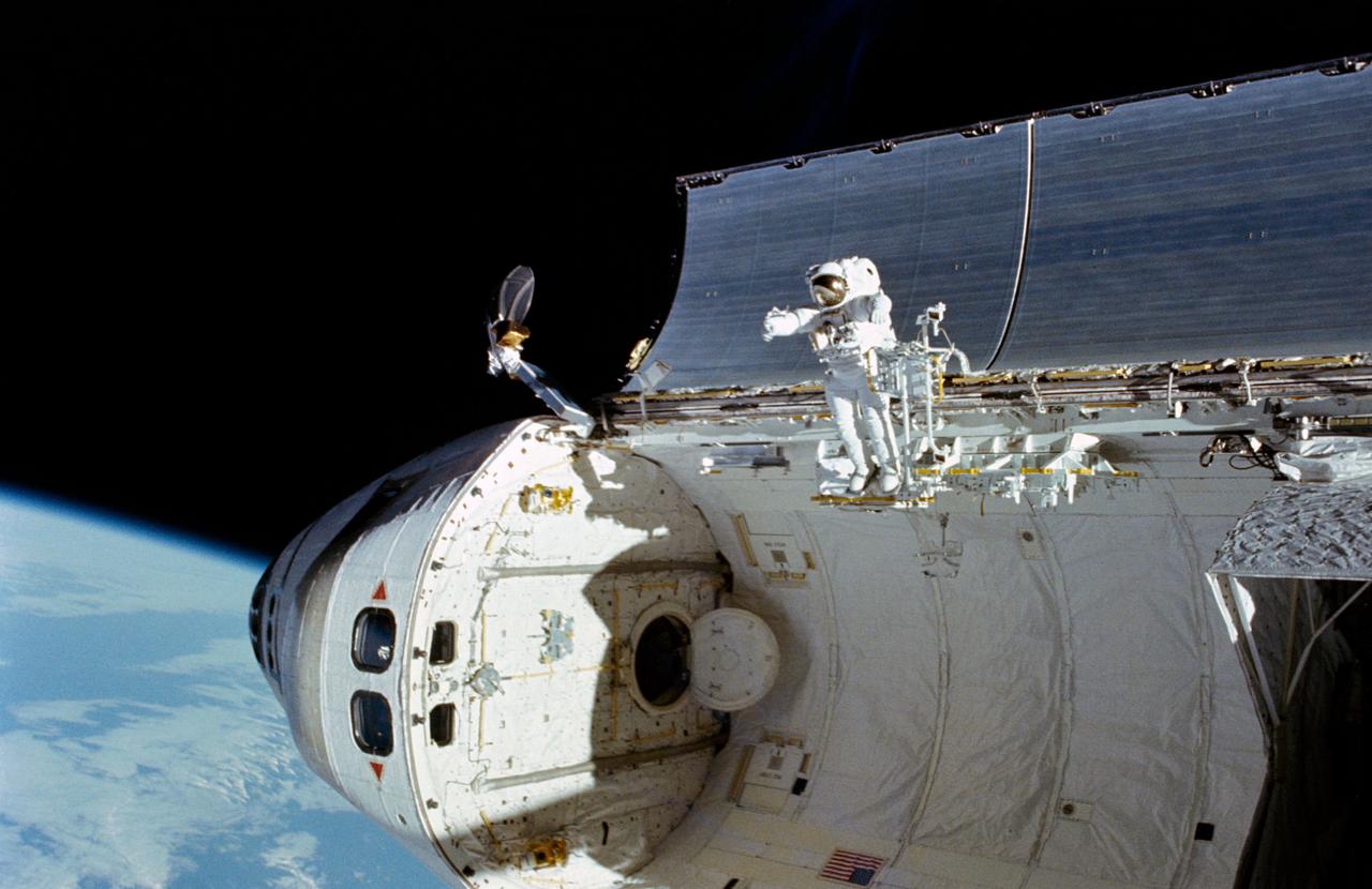 51I-102-048 (4-5 Sept 1985) --- A 35mm frame showing astronaut William F. Fisher standing on the edge of Discovery's cargo bay (in foot restraint) during the second day of a two-day effort to capture, repair and re-release the Syncom IV-3 communications satellite.  Astronaut James D. van Hoften, standing on the Discovery's RMS arm, exposed the frame.