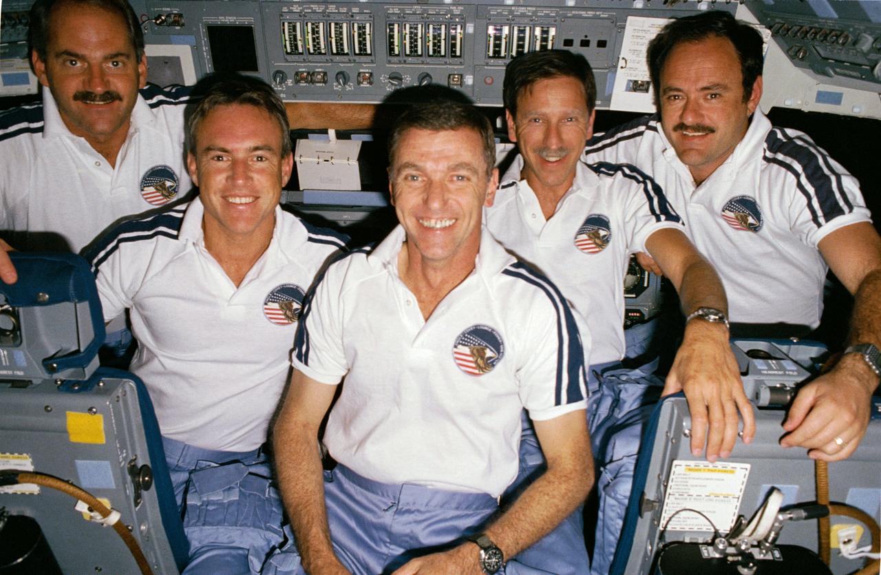 51I-17-029 (Aug-Sept 1985) --- A group portrait, recorded by a pre-set 35mm camera, shows all five STS- 51-I crewmembers on the flight deck of the Earth-orbiting Discovery in early September 1985, following the successful Syncom repair performed by the crewmembers. Left to right are Astronauts James D. van Hoften, William F. Fisher, Joe H. Engle, Richard O. Covey and John M. (Mike) Lounge.