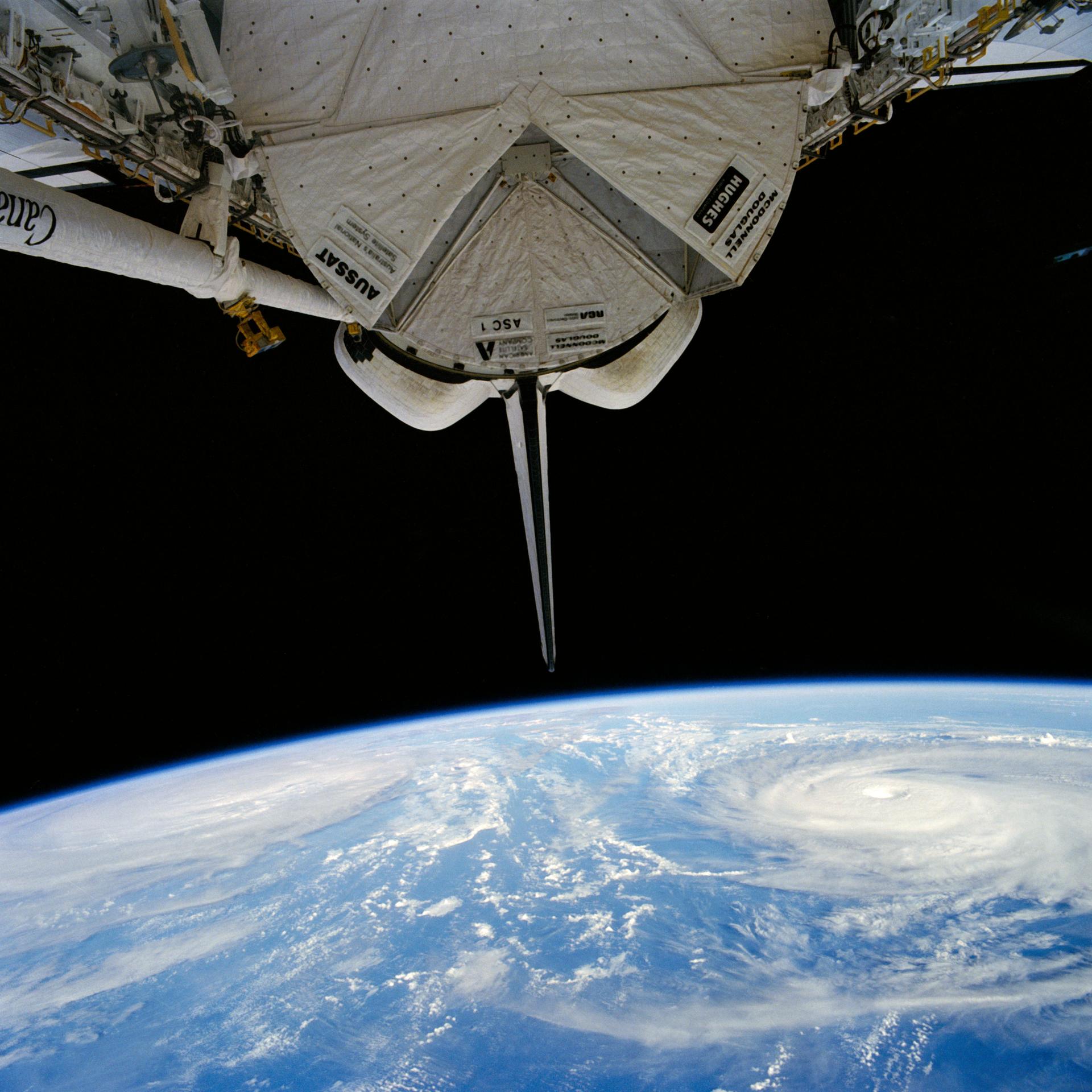 Two cyclones are visible over the Pacific Ocean as seen from STS-51I