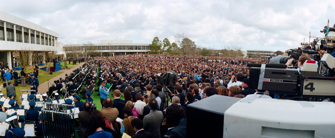 51L-S-127 (31 Jan. 1986) --- A wide angle lens was used to capture only a portion of the crowd gathered for memorial services for the seven members of the STS-51L Challenger crew at the Johnson Space Center. President Ronald Reagan speaks at the lectern at far left edge of the frame. The photographer for the picture was positioned on a large platform erected to accommodate the many members of the news media on hand for the event. Photo credit: NASA