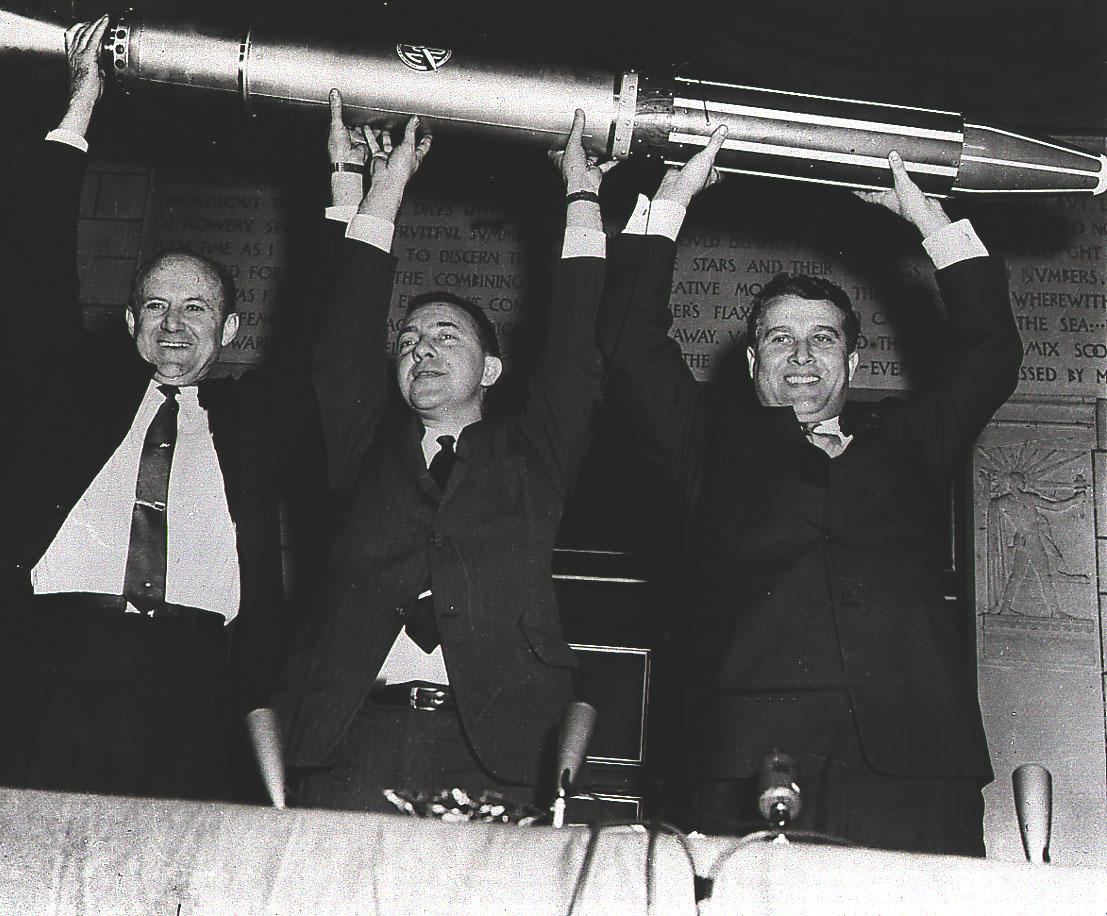 Dr. William Pickering, Dr. James van Allen, and Dr. Wernher von Braun triumphantly display a model of the Explorer I