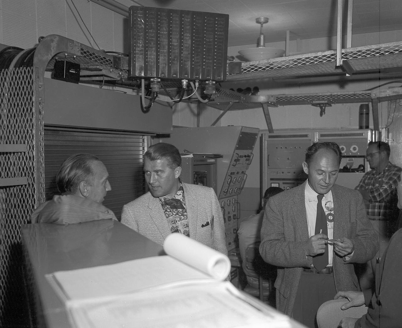 In this photo, (left to right) Army Ballistic Missile Agency (ABMA) Missile Firing Laboratory Chief Dr. Kurt Debus, Director of the ABMA Development Operations Division, Dr. von Braun and an unidentified individual in blockhouse during the CM-21 (Jupiter) firing. The Jupiter missile CM-21 became the first Chrysler production qualification missile to be fired and in March 1959 launched the Pioneer IV.
