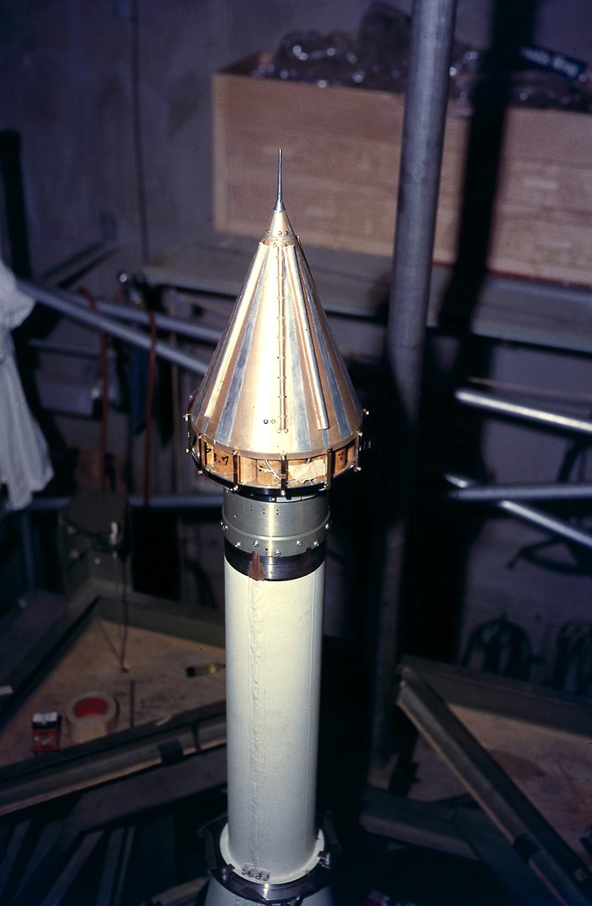 Installing Pioneer IV, payload for AM-14 (Juno II) onto the fourth stage on the cluster before a spin test, February 16, 1959. The Pioneer IV, lunar and planetary exploration satellite, was the first U.S. satellite to orbit the Sun.