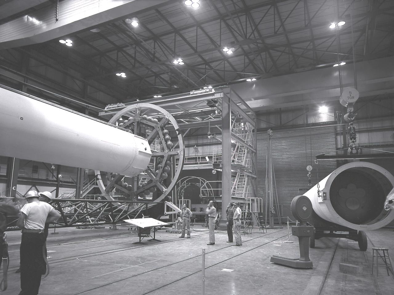 The Saturn I liquid-oxygen (LOX) tank for the Saturn I S-I stage being aligned with the end spider beam in the fabrication and engineering laboratory, building 4705, at the Marshall Space Flight Center (MSFC).