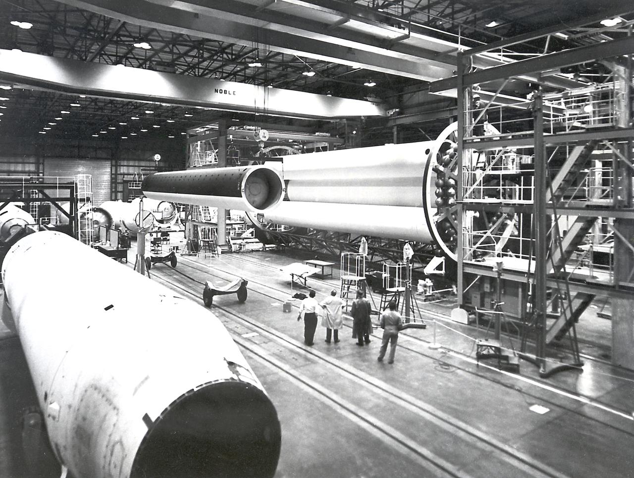 The Saturn I S-I stage is being assembled in the fabrication and engineering laboratory at the Marshall Space Flight Center. The two end spider beams are cornected to the central 267-centimeter diameter liquid-oxygen (LOX) tank. The 178-centimeter outer tank, used alternately for liquid oxygen and kerosene, is being lifted into position. 