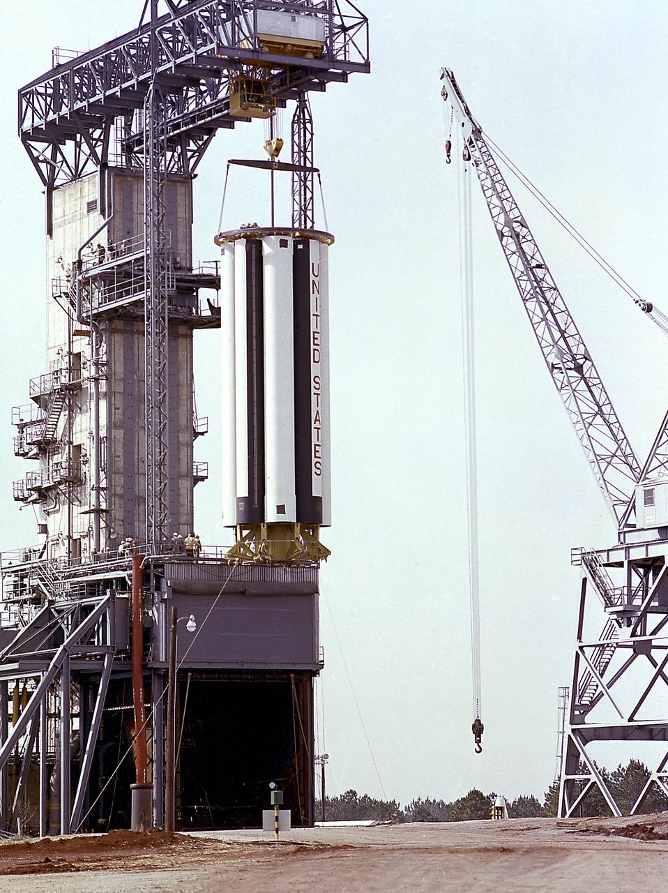 The Saturn Project was approved on January 18, 1960, as a program of the highest national priority. The formal test program to prove out the clustered-booster concept was well underway at Redstone Arsenal. This photograph depicts a mockup of the Saturn booster (S-I stage) being installed in the Army Ballistic Missile Agency (ABMA) test stand, on January 19, 1960, to check mating of the booster and stand and servicing methods.