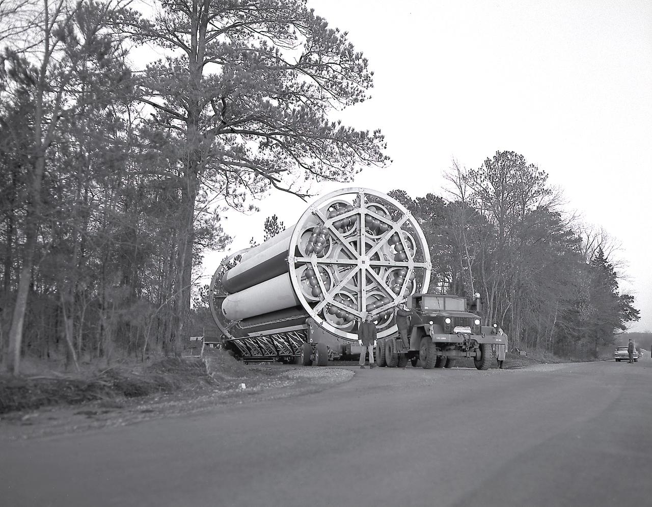 The Saturn Project was approved on January 18, 1960 as a program of the highest national priority. The formal test program to prove out the clustered-booster concept was well underway at Redstone Arsenal. This photograph depicts a mockup of the Saturn booster (S-I stage) being transported to the Army Ballistic Missile Agency (ABMA) test stand, to check mating of the booster and stand and servicing methods.