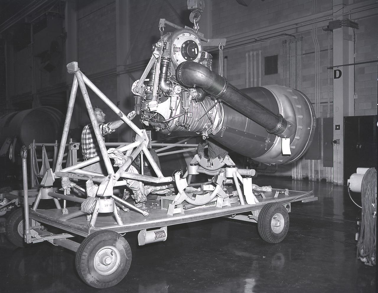 Alignment of the H-1 engine performed in the Army Ballistic Missile Agency (ABMA ), building 4708, in February 1960. A cluster of eight H-1 engines were used to thrust the first stage of the Saturn I launch vehicle. The H-1 engine was developed under the direction of the Marshall Space Flight Center.