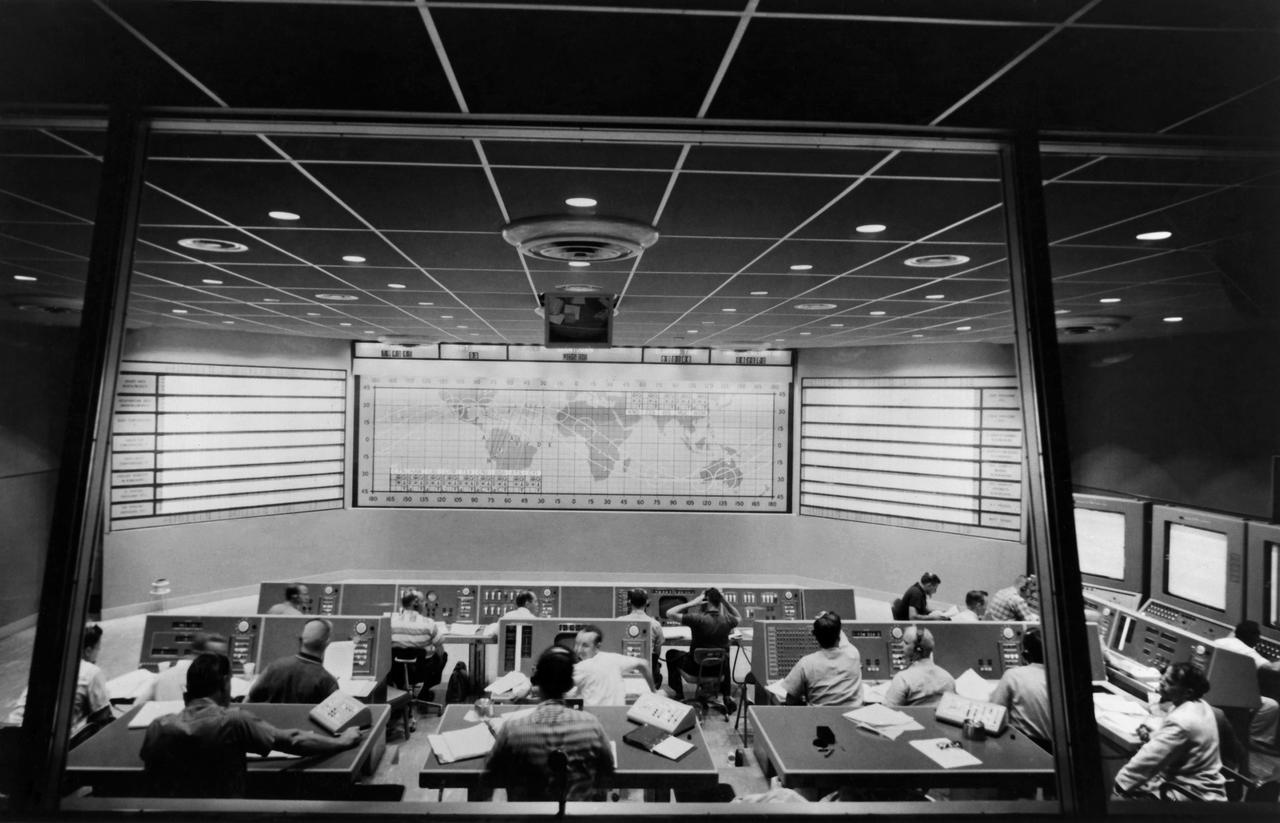 CAPE CANAVERAL, Fla. - Flight controllers gather inside Mercury Mission Control for Alan Shepard's Freedom 7 mission, which launched on May 5, 1961.       The Mercury Mission Control Center in Florida played a key role in the United States' early spaceflight program. Located at Cape Canaveral Air Force Station, the original part of the building was constructed between 1956 and 1958, with additions in 1959 and 1963. The facility officially was transferred to NASA on Dec. 26, 1963, and served as mission control during all the Project Mercury missions, as well as the first three flights of the Gemini Program, when it was renamed Mission Control Center. With its operational days behind, on June 1, 1967, the Mission Control Center became a stop on the public tour of NASA facilities until the mid-90s. In 1999, much of the equipment and furnishings from the Flight Control Area were moved to the Kennedy Space Center Visitor Complex where they became part of the exhibit there. The building was demolished in spring 2010. Photo credit: NASA