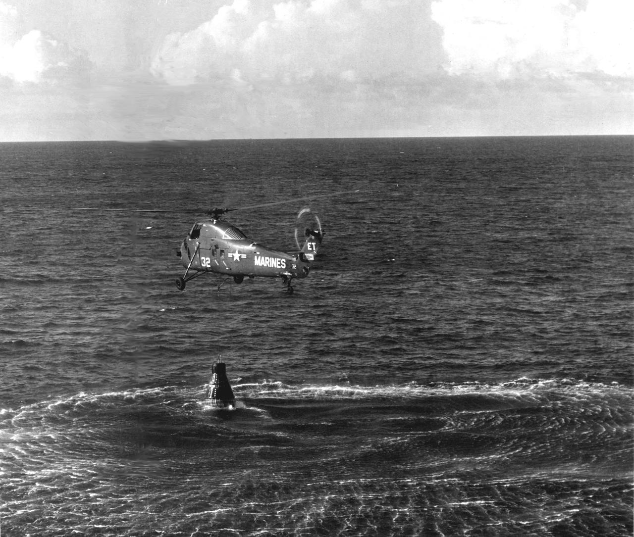 KENNEDY SPACE CENTER, FLA. -- Marine helicopter appears to have Liberty Bell 7 in tow after Virgil I. Grissom's successful flight of 305 miles down the Atlantic Missile Range.  Minutes after 'Gus' Grissom got out of the spacecraft, it sank.  (NASA Photo