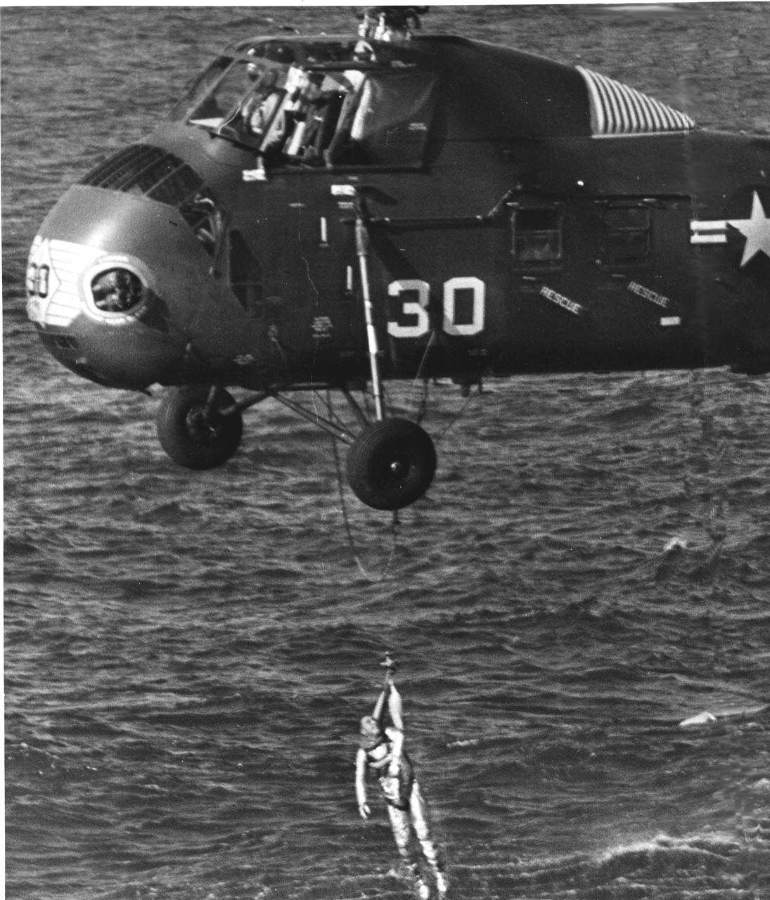 KENNEDY SPACE CENTER, FLA. -- Marine helicopter has astronaut Virgil I. Grissom in harness and is bringing him up out of the water.  The Liberty Bell 7 spacecraft has just sunk below the water.  His Mercury-Redstone 4 launch was the second in the U.S. manned space effort.