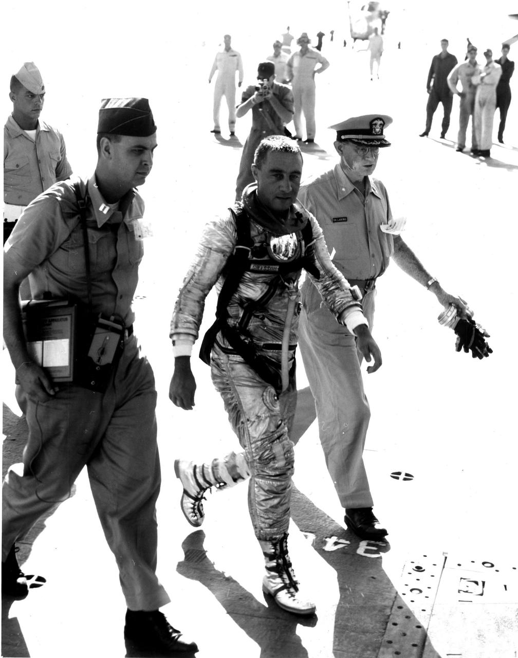 KENNEDY SPACE CENTER, FLA. -- Astronaut Virgil I. Grissom walks across the deck of the U.S.S. Randolph after being airlifted by helicopter from the Liberty Bell 7 impact area.  'Gus' Grissom was the second U.S. man in space.  (NASA Photo)