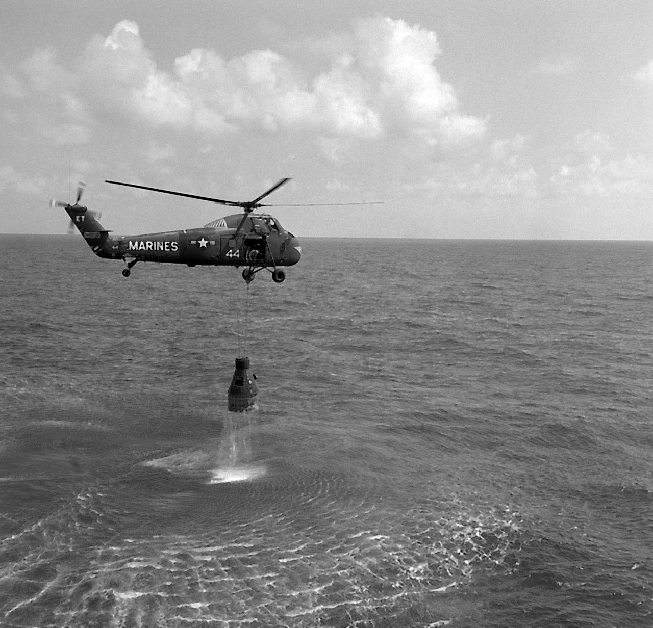 This photo depicts the recovery of the Freedom 7 (MR-3) capsule by a U.S. Marine helicopter. The MR-3 mission successfully placed the first American astronaut, Alan Shepard, in space for 15-1/2 minutes and returned safely to Earth on May 5, 1961. 