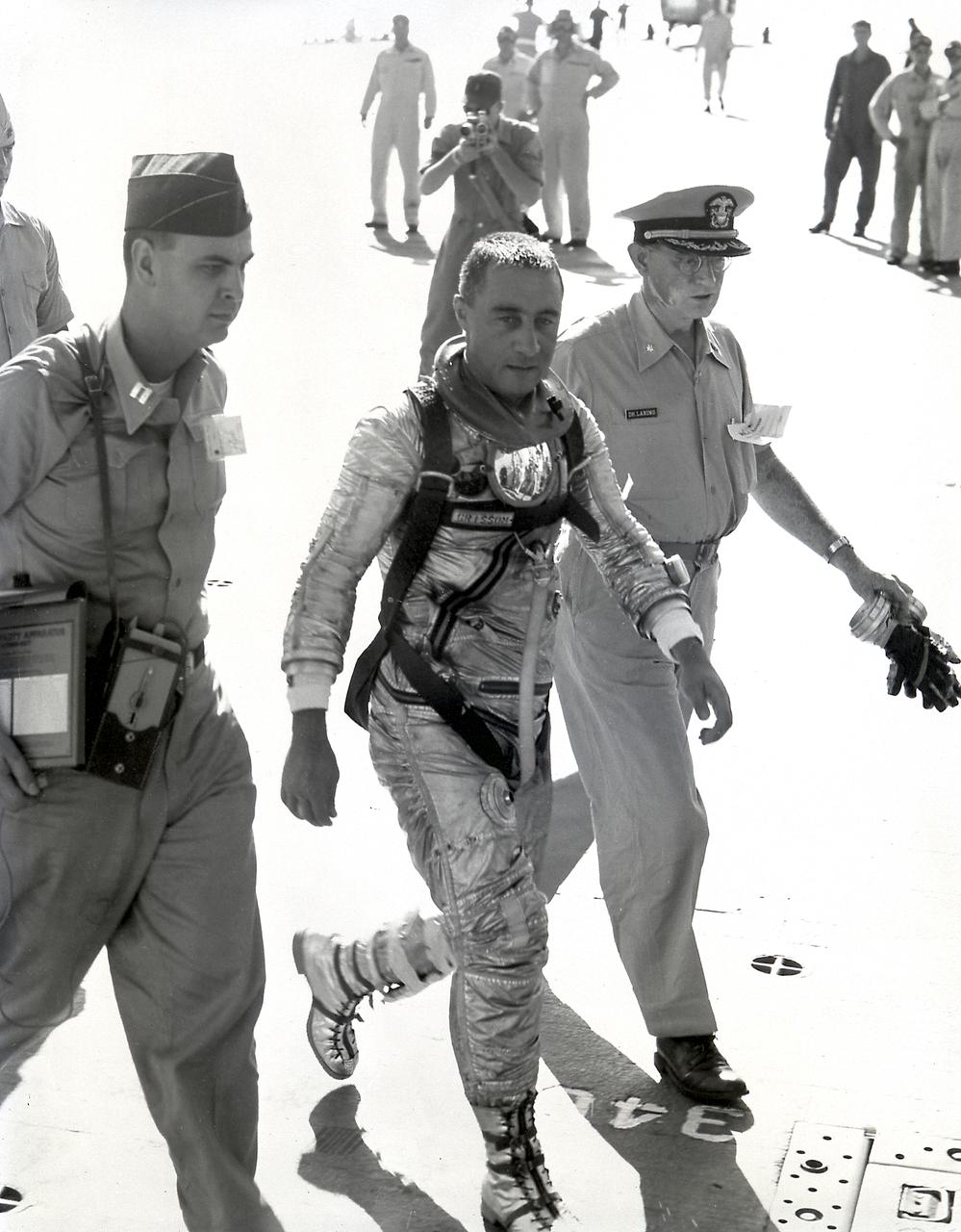 Astronaut Virgil Grissom walks on the recovery ship after completing the 15-1/2-minute suborbital MR-4 mission.