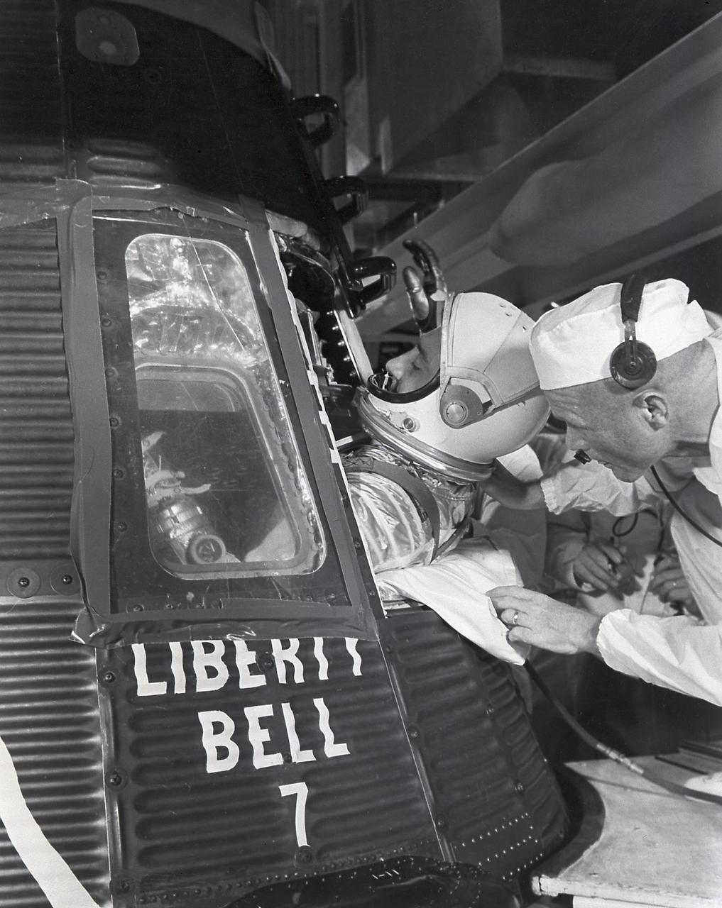 Assisted by Astronaut John Glenn, Astronaut Virgil Grissom enters the Mercury capsule, Liberty Bell 7, for the MR-4 mission on July 21, 1961. Boosted by the Mercury-Redstone vehicle, the MR-4 mission was the second manned suborbital flight.