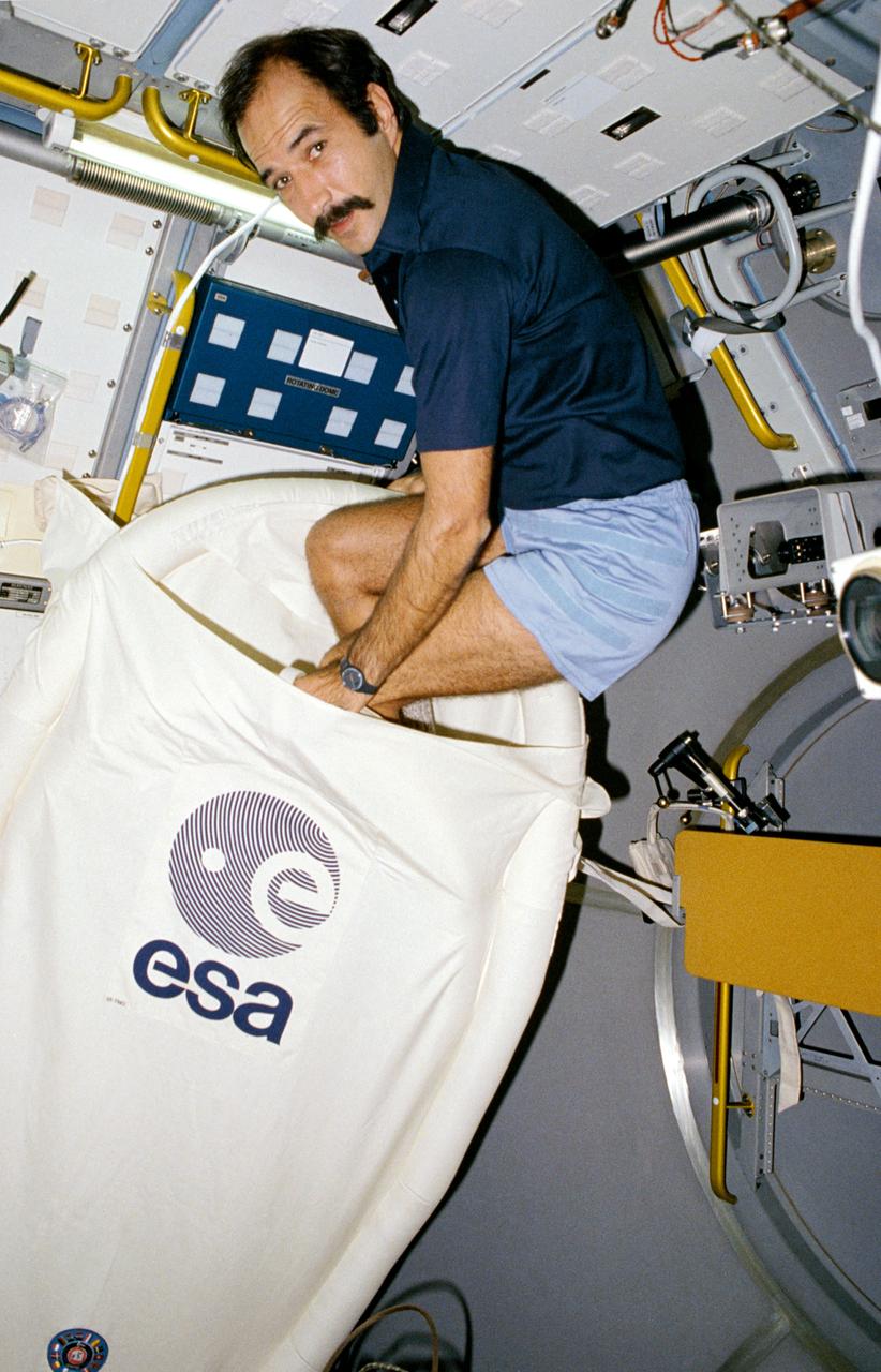 61A-08-018 (30 Oct.-6 Nov. 1985) --- Wubbo J. Ockels, a Dutch scientists representing the European Space Agency (ESA), crawls from an unique sleeping restraint in D-1 science module. Unlike the other crewmembers on STS 61A, Ockels did not sleep in the middeck of the Challenger. Ockels proposed this concept of sleeping facility and the actual hardware was developed by the Technisch Natur Wetenschappelyk Onderzoek (TNO), a Dutch government organization.