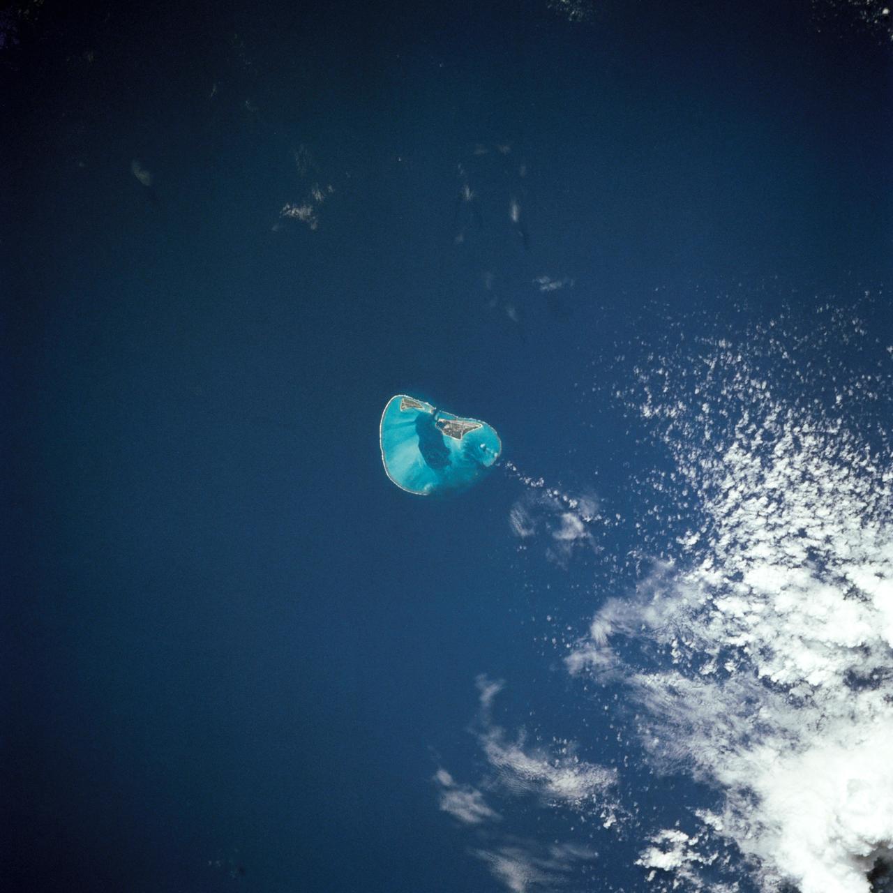 61A-40-38 (30 Oct-6 Nov 1985) --- The coral reef forming the atoll of Midway sits atop a volcanic seamount that has descended more than 3,000 feet (1000 meters) below the sea surface in this ancient region of the Hawaiian volcanic chain.  This view was taken by the crew members onboard the Earth-orbiting Space Shuttle Challenger.  The crew consisted of astronauts Henry W. Hartsfield, Jr., commander; Steven R. Nagel, pilot; James F. Buchli, Guion S. Bluford, Jr., and Bonnie J. Dunbar, all mission specialists; Reinhard Furrer, Ernst Messerschmid, and Wubbo J. Ockels, all payload specialists.  Ockels represents the European Space Agency (ESA).