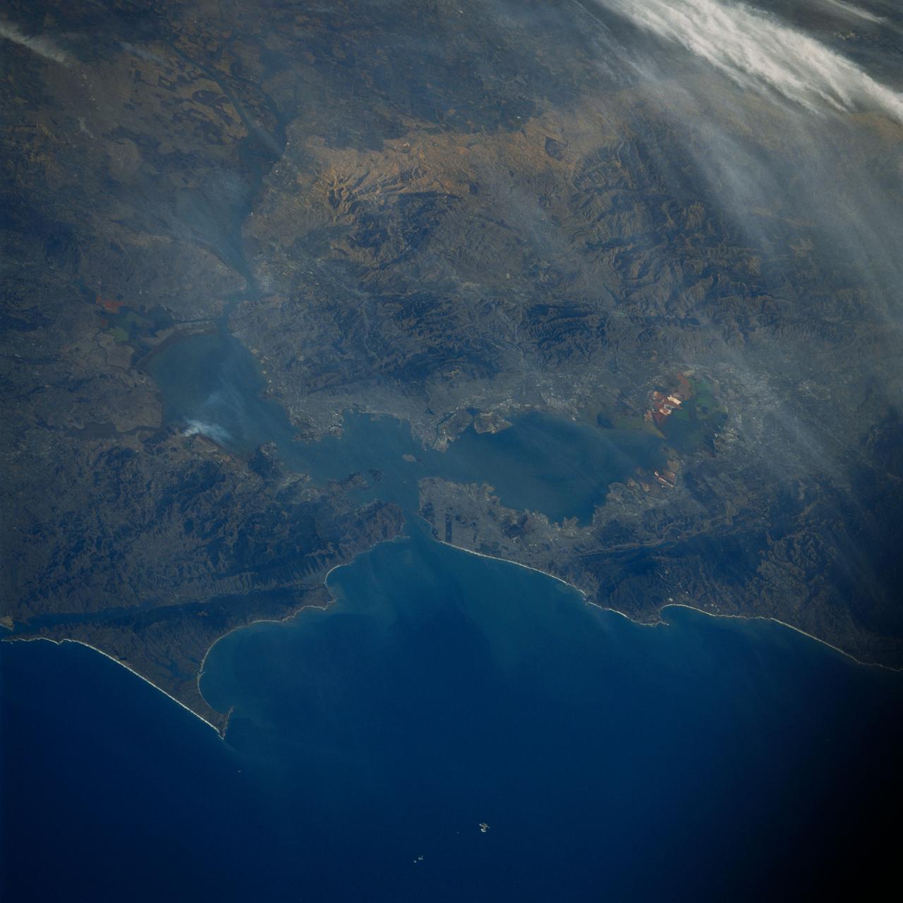61A-51-045 (31 Oct 1985) --- San Francisco Bay and the San Andreas fault line stand out in this 70mm frame exposed from the Earth-orbiting Space Shuttle Challenger on October 31, 1985.  The California coastline extends from Tomales Bay on the north almost to Santa Cruz (just out of frame) on the south.  Parts of the Sacramento and San Joaquin valleys are seen along the frame's right edge.  Some of the bay's salt evaporators are recognizable by their unique hews, near Fremont and near Vallejo.  Center point coordinates are located at 37.5 degrees north latitude and 122.5 degrees west longitude.  The Challenger was 180 nautical miles directly above a point centered at 38.8 degrees north latitude and 126.5 degrees west longitude.