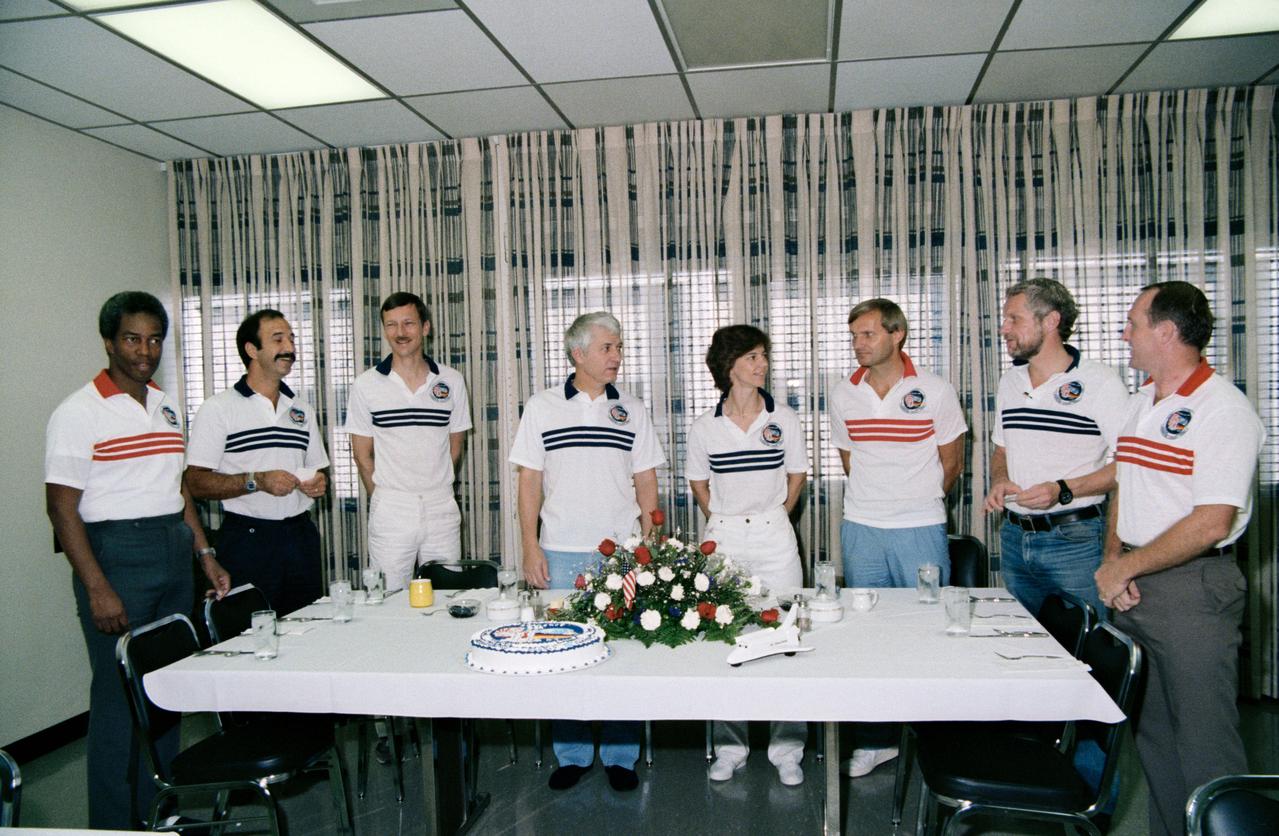 61A-S-016 (30 Oct  1985) --- Standing near their pre-flight breakfast table are the eight crewmembers for the STS 61-A/Spacelab D1 mission.  L.-R., Guion S. Bluford, Wubbo J. Ockels, Steven R. Nagel, Henry W. Hartsfield, Bonnie J. Dunbar, Ernst Messerschmid, Reinhard Furrer and James F. Buchli, discuss their upcoming week in space.