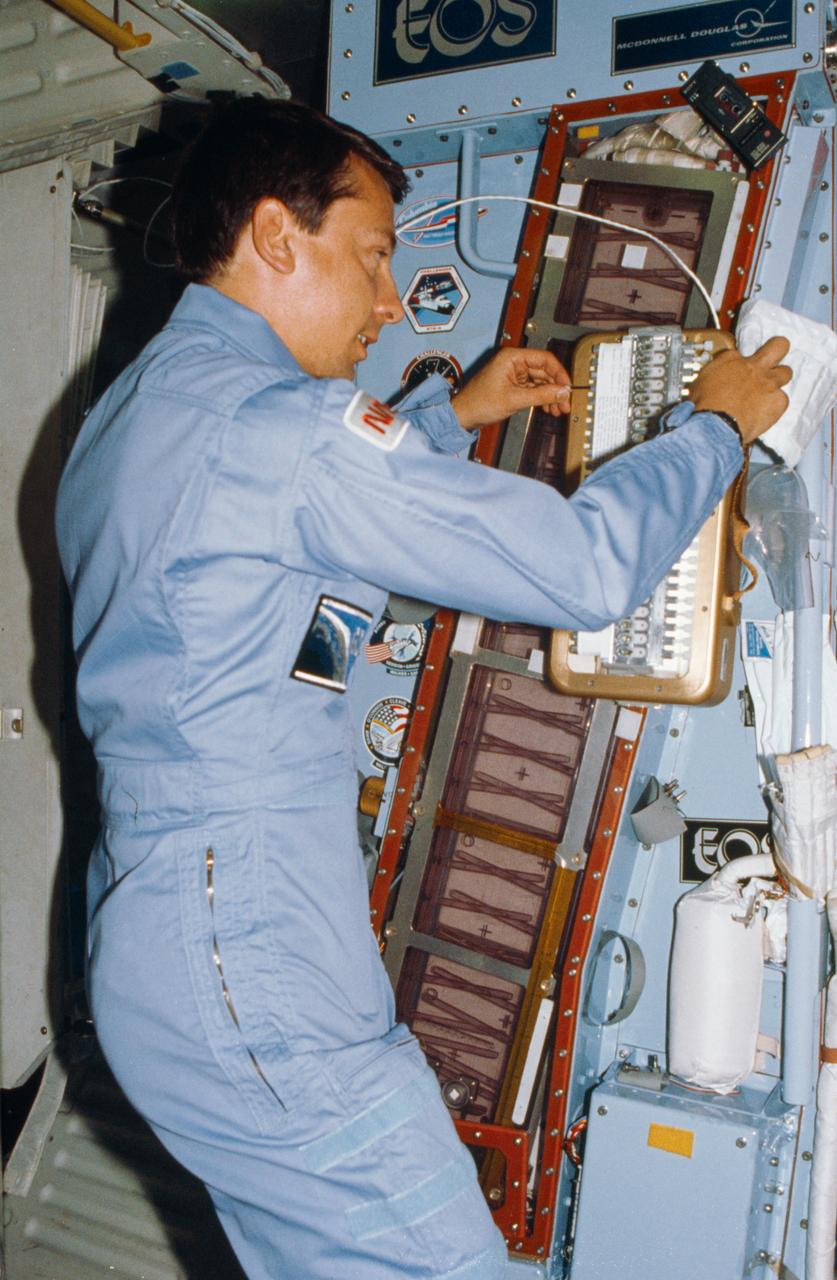 61B-02-014 (26 Nov-3 Dec 1985) --- Payload Specialist Charles D. Walker works with the handheld protein growth experiment -- one of a series of tests being flown to study the possibility of crystallizing biological materials.  Walker rests the experiment against the larger continuous flow electrophoresis systems experiment.