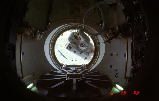 Astronaut Jerry Ross at threshold of airlock compartment following EVA
