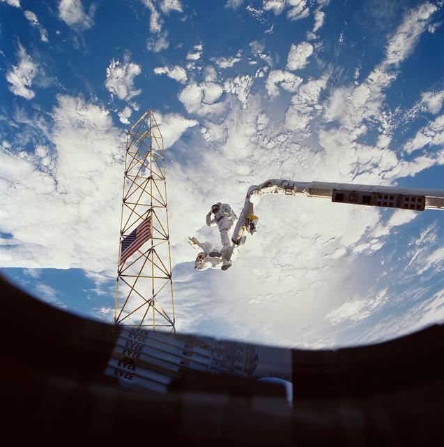 NASA image: Astronauts Jerry Ross and Sherwood Spring survey assembled ACCESS components
