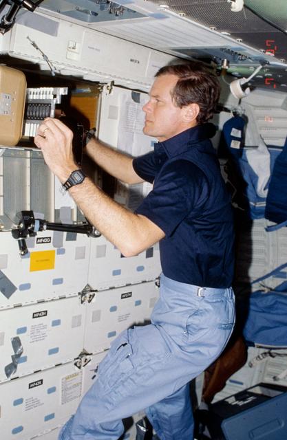 NASA image: Rep. Bill Nelson prepares to photograph samples of protein crystal growth