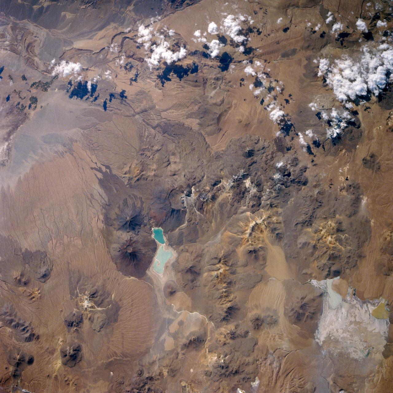 61C-32-089 (12 Jan. 1986) --- This nearly-vertical handheld Hasselblad image over Chile was photographed from an altitude of 176 nautical miles during the sixth orbit of the space shuttle Columbia on Jan. 12, 1986. Many of the noted Andes volcanoes can be seen in the frame. Laguna Verde (Green Lake) is near the center of the frame. Center coordinates are located at 22.5 degrees south latitude and 68 degrees west longitude. The shuttle was 176 nautical miles above a point centered at 21.8 degrees south latitude and 67.3 degrees west longitude.
