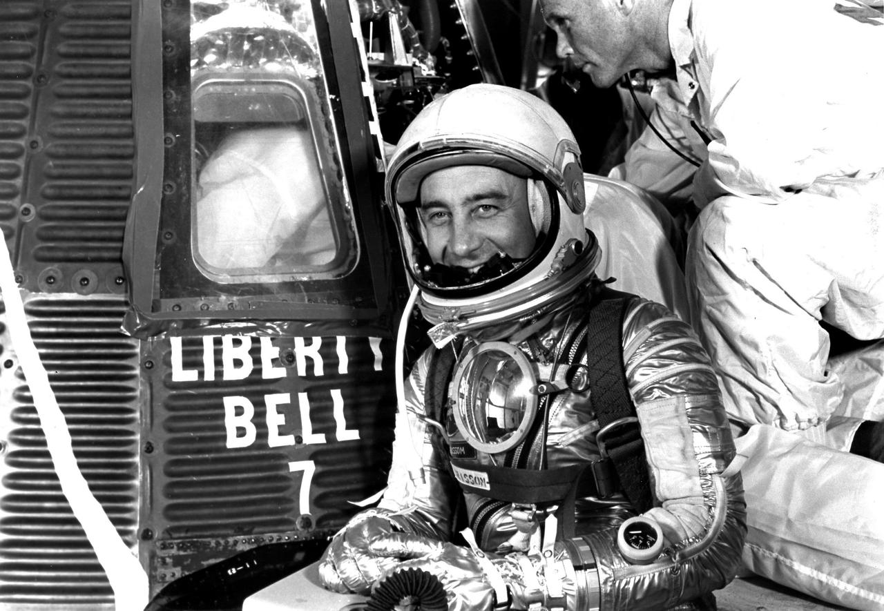 61-MR4-76 (1961) --- Astronaut Virgil I. (Gus) Grissom, suited up and ready to climb into Liberty Bell 7 spacecraft, poses for a picture. Backup pilot John Glenn is in the right corner of the view behind Grissom. The Mercury-Redstone 4 (MR-4) mission was scrubbed a few hours later due to unfavorable weather over the launch pad. Photo credit: NASA