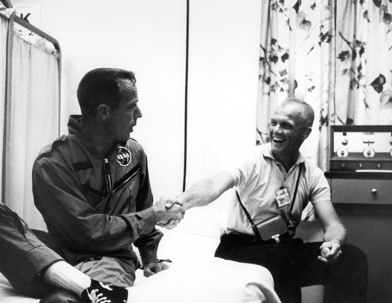 CAPE CANAVERAL, Fla. -- John Glenn congratulates Scott Carpenter on his three-orbit mission aboard the Aurora 7 spacecraft.    Photo credit: NASA