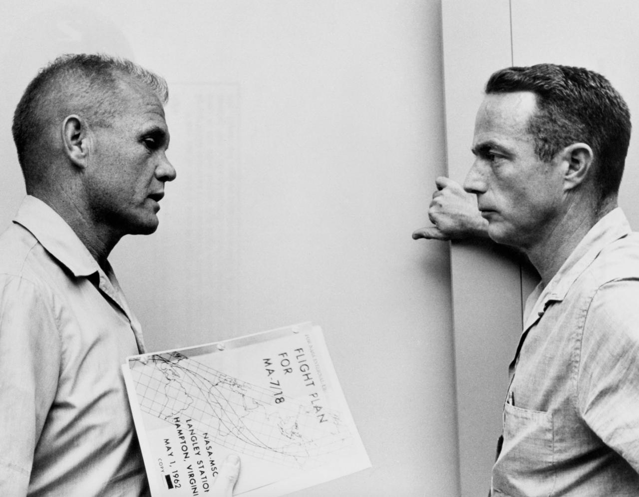CAPE CANAVERAL, Fla. -- John Glenn and Scott Carpenter go over the flight plan for MA-7 mission. Photo credit: NASA
