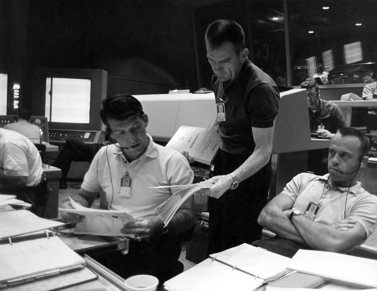 CAPE CANAVERAL, Fla. - Mercury astronauts, from left, Wally Schirra, Deke Slayton and Alan Shepard work inside the Mercury Control Center where they were stationed during the Faith 7 mission of astronaut Gordon Cooper, launched on May 15, 1963. This was the final mission of the Mercury Program.     The Mercury Mission Control Center in Florida played a key role in the United States' early spaceflight program. Located at Cape Canaveral Air Force Station, the original part of the building was constructed between 1956 and 1958, with additions in 1959 and 1963. The facility officially was transferred to NASA on Dec. 26, 1963, and served as mission control during all the Project Mercury missions, as well as the first three flights of the Gemini Program, when it was renamed Mission Control Center. With its operational days behind, on June 1, 1967, the Mission Control Center became a stop on the public tour of NASA facilities until the mid-90s. In 1999, much of the equipment and furnishings from the Flight Control Area were moved to the Kennedy Space Center Visitor Complex where they became part of the exhibit there. The building was demolished in spring 2010. Photo credit: NASA