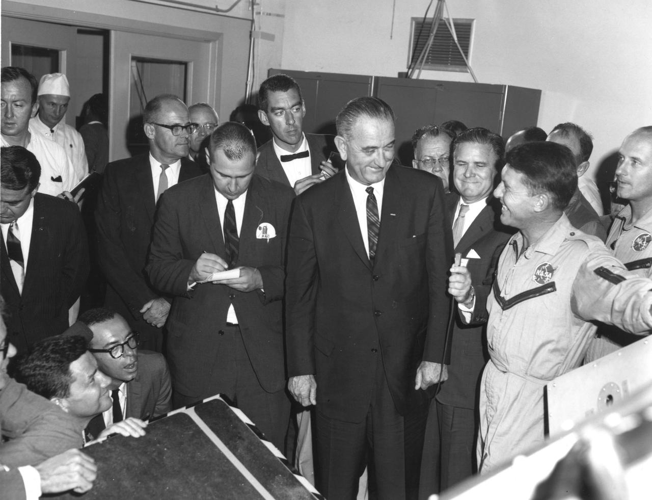 KENNEDY SPACE CENTER, FLA. -- NASA Administrator James T. Webb holds the microphone as President Lyndon B. Johnson (center) and astronaut Walter Schirra (right) converse during the President's visit to the Kennedy Space Center.