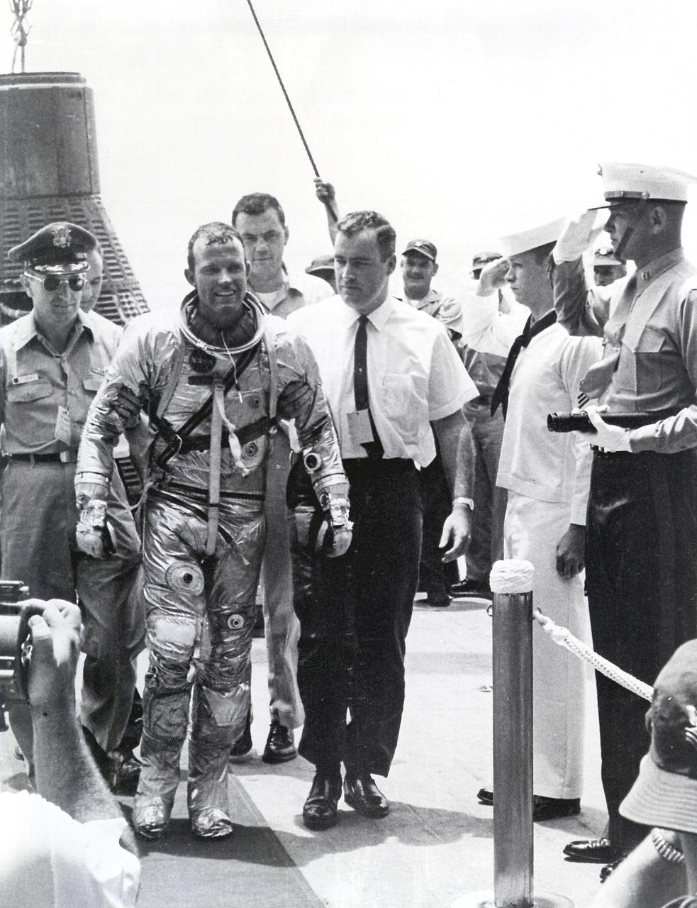 Astronaut Gordon Cooper leaves the Faith 7 (MA-9) spacecraft after a successful recovery operation. The MA-9 mission, the last flight of the Mercury Project, was launched on May 15, 1963, orbited the Earth 22 times, and lasted for 1-1/2 days.
