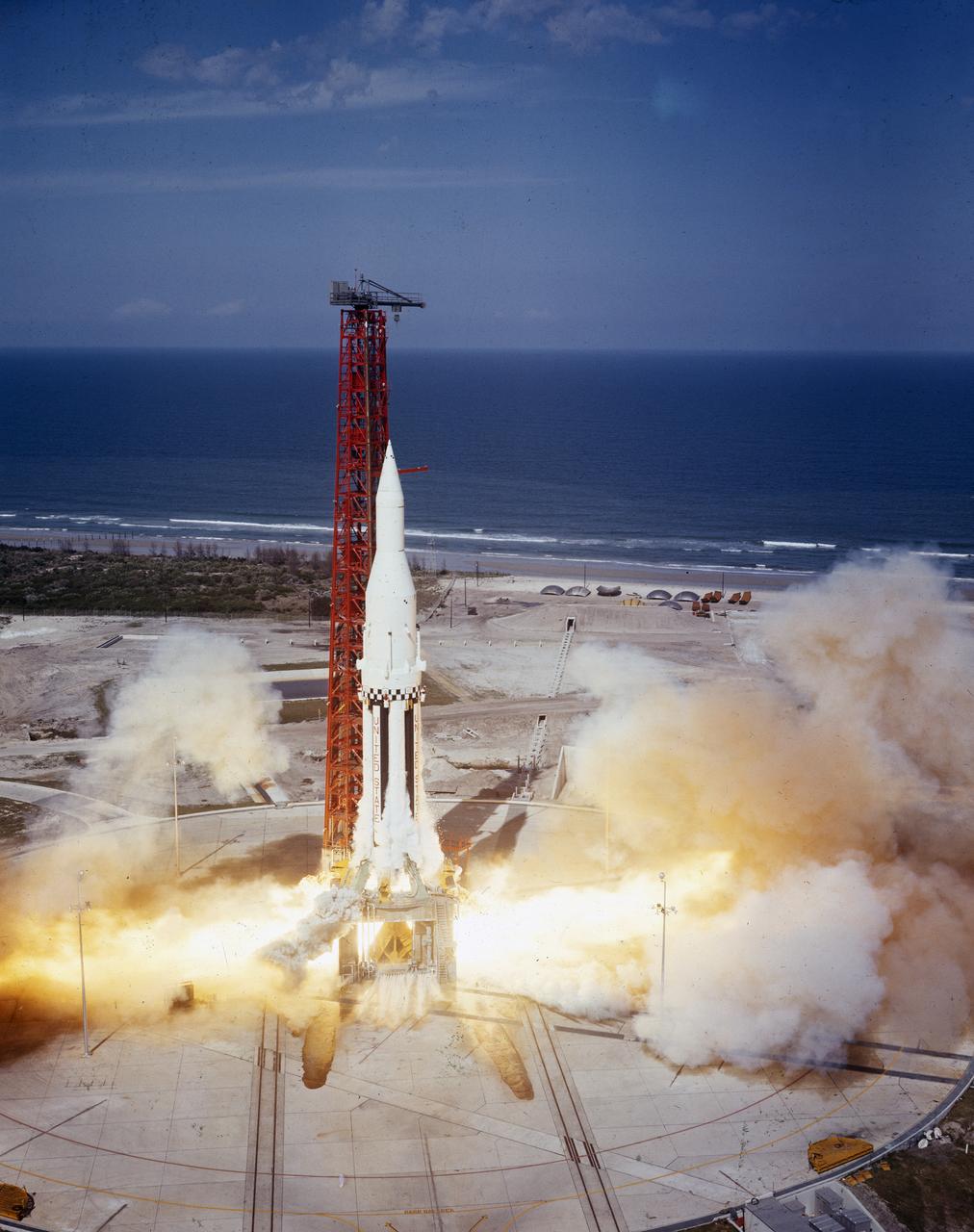 The Saturn I (SA-4) flight lifted off from Kennedy Space Center launch Complex 34, March 28, 1963. The fourth launch of Saturn launch vehicles developed at the Marshall Space Flight Center (MSFC), under the direction of Dr. Wernher von Braun, incorporated a Saturn I, Block I engine. The typical height of a Block I vehicle was approximately 163 feet and had only one live stage. It consisted of eight tanks, each 70 inches in diameter, clustered around a central tank, 105 inches in diameter. Four of the external tanks were fuel tanks for the RP-1 (kerosene) fuel. The other four, spaced alternately with the fuel tanks, were liquid oxygen tanks as was the large center tank. All fuel tanks and liquid oxygen tanks drained at the same rates respectively. The thrust for the stage came from eight H-1 engines, each producing a thrust of 165,000 pounds, for a total thrust of over 1,300,000 pounds. The engines were arranged in a double pattern.  Four engines, located inboard, were fixed in a square pattern around the stage axis and canted outward slightly, while the remaining four engines were located outboard in a larger square pattern offset 40 degrees from the inner pattern. Unlike the inner engines, each outer engine was gimbaled. That is, each could be swung through an arc. They were gimbaled as a means of steering the rocket, by letting the instrumentation of the rocket correct any deviations of its powered trajectory. The block I required engine gimabling as the only method of guiding and stabilizing the rocket through the lower atmosphere. The upper stages of the Block I rocket reflected the three-stage configuration of the Saturn I vehicle. Like SA-3, the SA-4 flight’s upper stage ejected 113,560 liters (30,000 gallons) of ballast water in the upper atmosphere for "Project Highwater" physics experiment. Release of this vast quantity of water in a near-space environment marked the second purely scientific large-scale experiment. The SA-4 was the last Block I rocket launch.