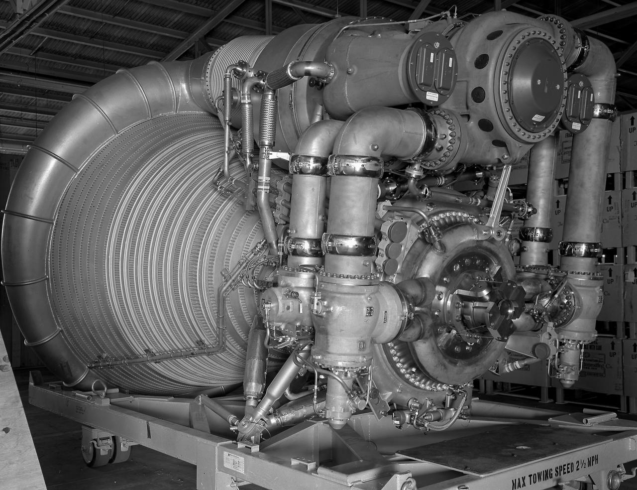 A close-up view of the F-1 Engine for the Saturn V S-IC (first) stage depicts the complexity of the engine. Developed by Rocketdyne under the direction of the Marshall Space Flight Center, the F-1 engine was utilized in a cluster of five engines to propel the Saturn V's first stage, the S-IC. Liquid oxygen and kerosene were used as its propellant. Initially rated at 1,500,000 pounds of thrust, the engine was later uprated to 1,522,000 pounds of thrust after the third Saturn V launch (Apollo 8, the first marned Saturn V mission) in December 1968. The cluster of five F-1 engines burned over 15 tons of propellant per second, during its two and one-half minutes of operation, to take the vehicle to a height of about 36 miles and to a speed of about 6,000 miles per hour. 