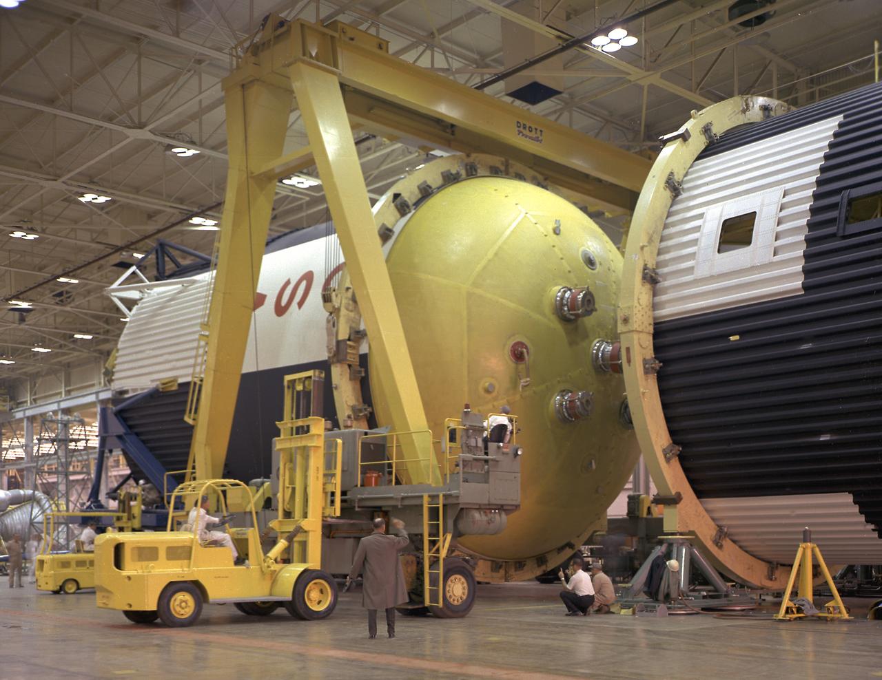 This photograph shows how the fuel tank assembly and the liquid oxygen tank for the Saturn V S-IC (first) stage are placed side by side prior to commencement of the mating of the two stages in the Marshall Space Flight Center, building 4705. The fuel tank carried kerosene as its fuel. The S-IC stage used five F-1 engines, that used kerosene and liquid oxygen as propellant and each engine provided 1,500,000 pounds of thrust. This stage lifted the entire vehicle and Apollo spacecraft from the launch pad.