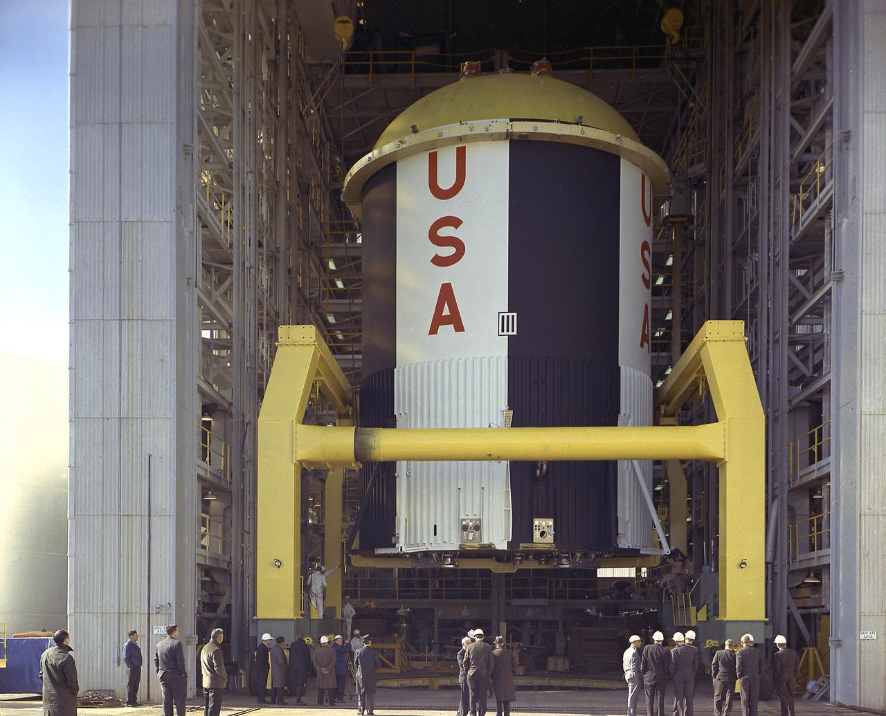 The fuel tank assembly of the Saturn V S-IC (first) stage supported with the aid of a C frame on the transporter was readied to be transported to the Marshall Space Flight Center, building 4705. The fuel tank carried kerosene (RP-1) as its fuel. The S-IC stage utilized five F-1 engines that used kerosene and liquid oxygen as propellant and each engine provided 1,500,000 pounds of thrust. This stage lifted the entire vehicle and Apollo spacecraft from the launch pad.