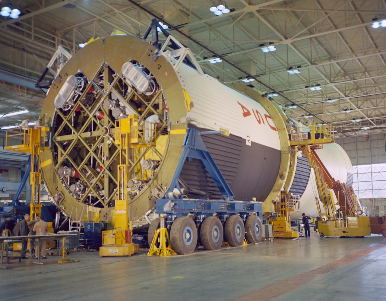 At the Marshall Space Flight Center (MSFC), the fuel tank assembly for the Saturn V S-IC-T (static test stage) fuel tank assembly is mated to the liquid oxygen (LOX) tank in building 4705. This stage underwent numerous static firings at the newly-built S-IC Static Test Stand at the MSFC west test area. The S-IC (first) stage used five F-1 engines that produced a total thrust of 7,500,000 pounds as each engine produced 1,500,000 pounds of thrust. The S-IC stage lifted the Saturn V vehicle and Apollo spacecraft from the launch pad. 