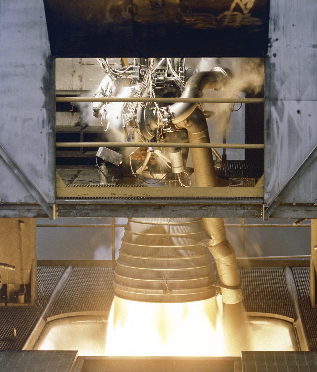 A close-up image of the single H-1 engine was test-fired at Canoga Park, California. Initial development of testing for the H-1 engine took place in the engineering facilities at Rocketdyne's main plant in Canoga Park, California.