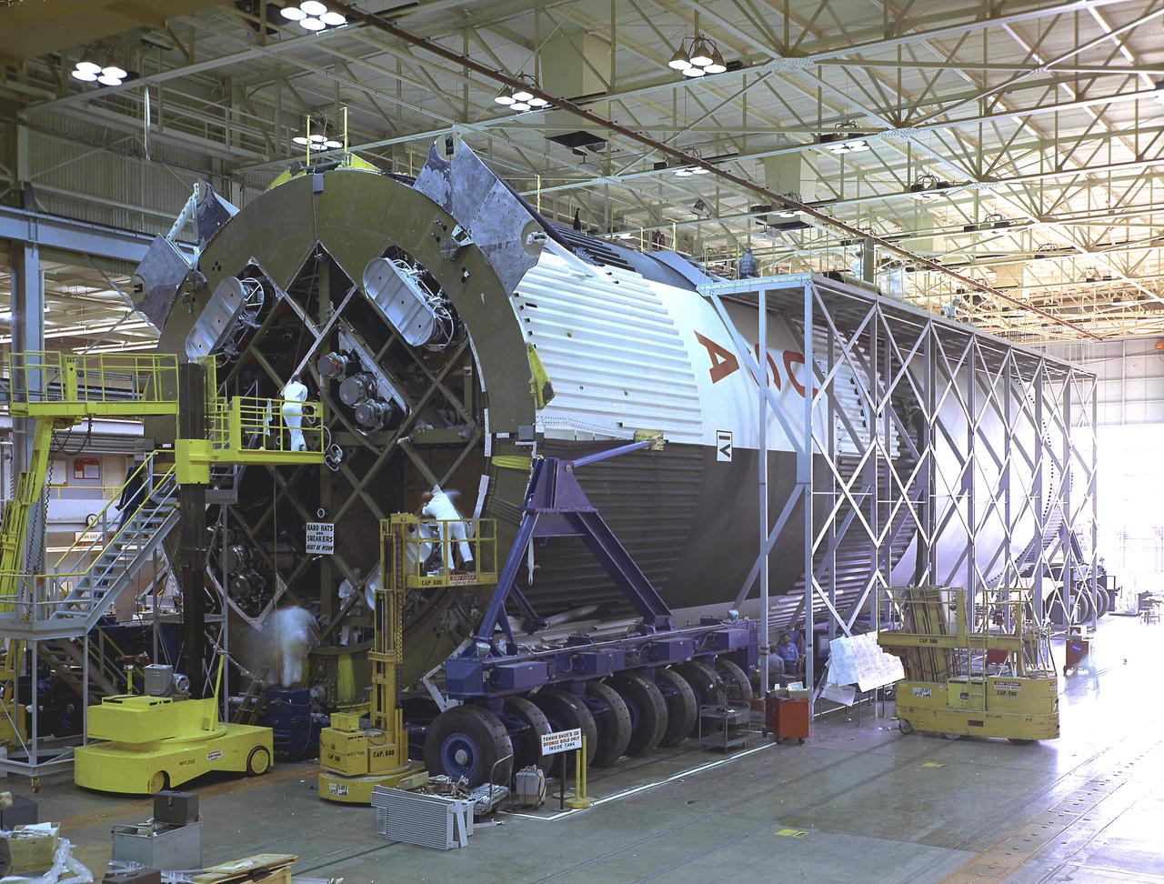 Pictured is the Saturn V S-IC-T stage (static testing stage) being assembled in the horizontal assembly station at the Marshall Space Flight Center (MSFC), building 4705. This stage underwent numerous static firings at the newly-built S-IC Static Test Stand at the MSFC west test area. The S-IC (first) stage used five F-1 engines that produced a total thrust of 7,500,000 pounds as each engine produced 1,500,000 pounds of thrust. The S-IC stage lifted the Saturn V vehicle and Apollo spacecraft from the launch pad. 
