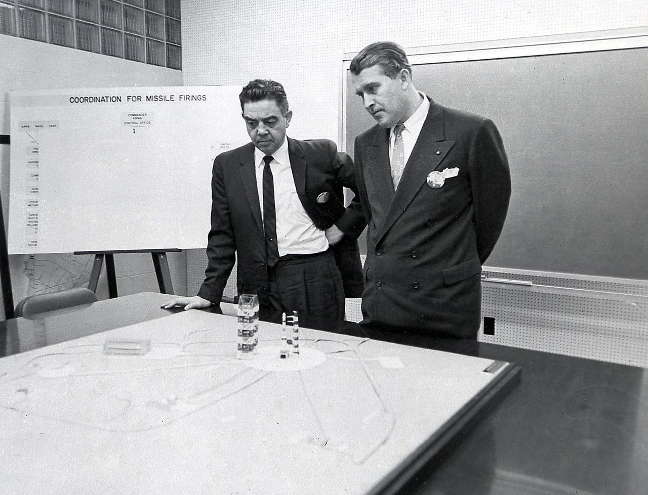 Dr. von Braun and Don Ostrander, head of the Launch Vehicle Program of the NASA Headquarters look at a model of the Saturn I launch complex 34.
