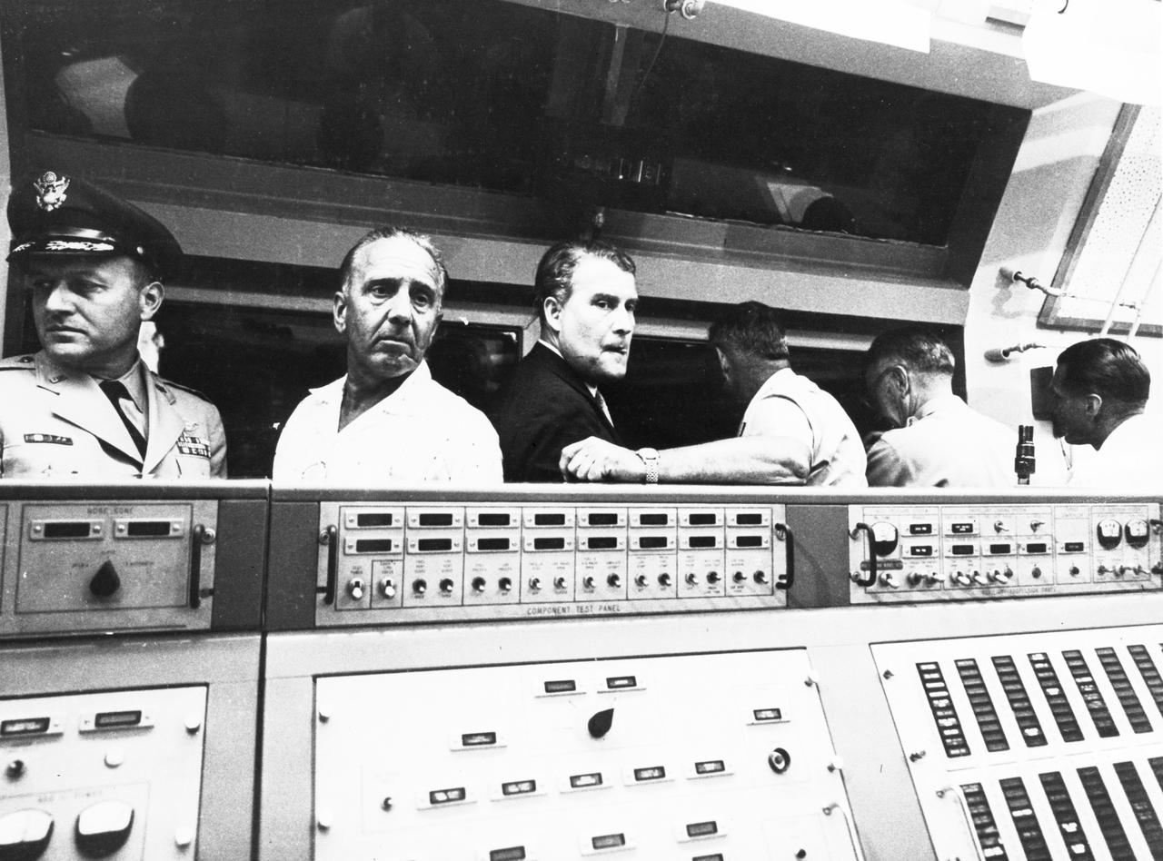 This photograph shows Dr. von Braun, second from the left, in the blockhouse at the Florida launch facilities on March 3, 1959. He and others gathered for the launch of the Pioneer IV satellite. On the left of Dr. von Braun is Kurt Debus, who managed the Florida launch facilities. To the right of Dr. von Braun is Army General John B. Medaris. Next to him is General John Barclay. At this time, Dr. von Braun and his associates were members of the Army Ballistic Missile Agency in Huntsville, Alabama.