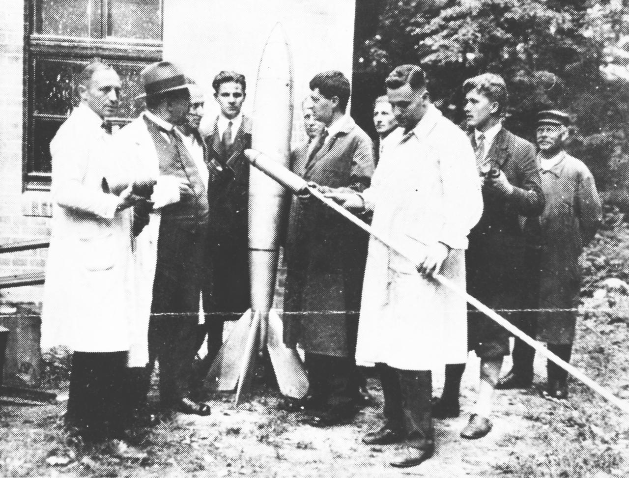 Dr. von Braun was among a famous group of rocket experimenters in Germany in the 1930s. This photograph is believed to be made on the occasion of Herman Oberth's Kegelduese liquid rocket engine being certified as to performance during firing. From left to right are R. Nebel, Dr. Ritter, Mr. Baermueller, Kurt Heinish, Herman Oberth, Klaus Riedel, Wernher von Braun, and an unidentified person.