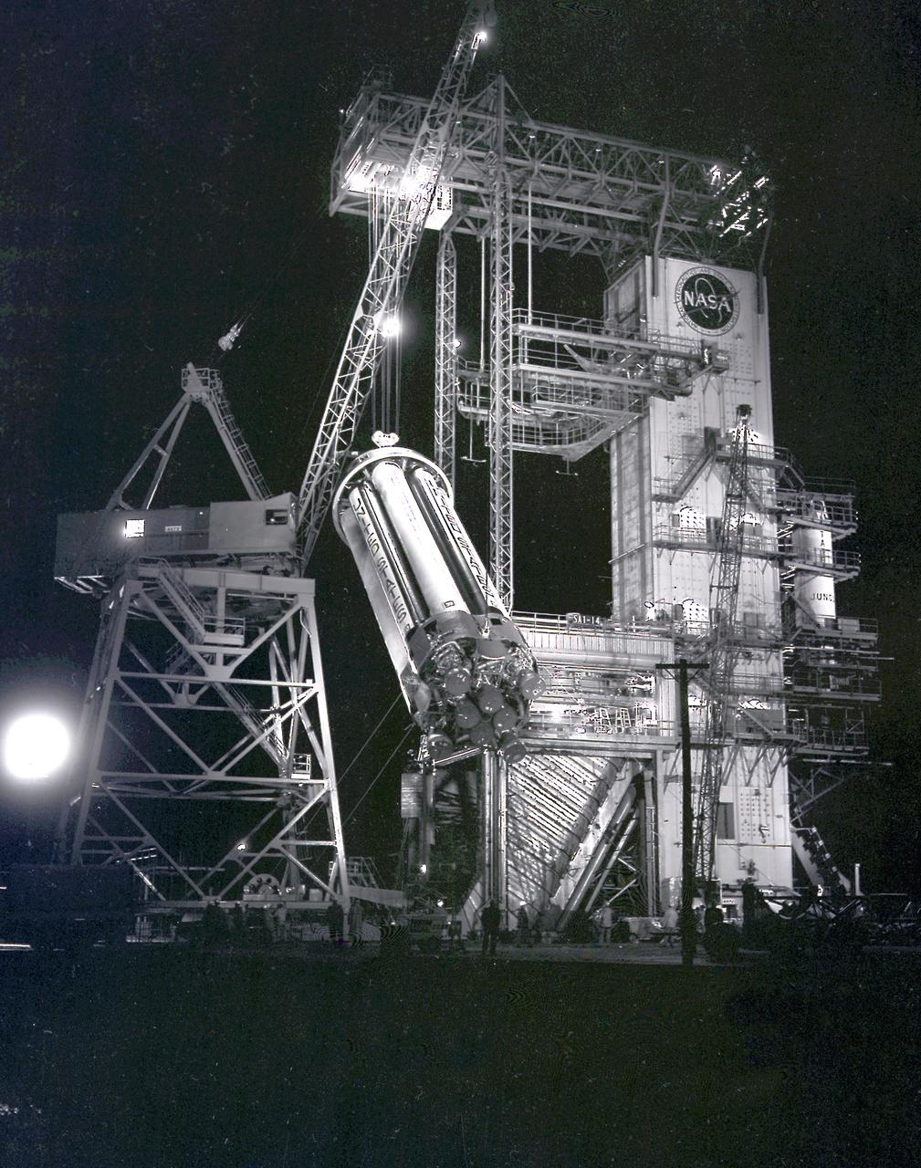 This night photograph depicts the SA-1 booster (Saturn I S-I stage) being removed from the test stand after the first flight qualification testing at the Marshall Space Flight Center (MSFC).