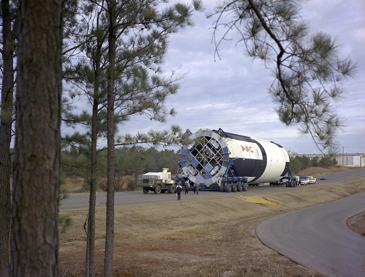 The Saturn V S-IC-T stage (static testing stage) was enroute from the Manufacturing Engineering Laboratory to the newly-built S-1C Static Test Stand at the Marshall Space Flight Center west test area. Known as S-IC-T, the stage was a static test vehicle not intended for flight. It was ground tested repeatedly over a period of many months proving the vehicle's propulsion system.