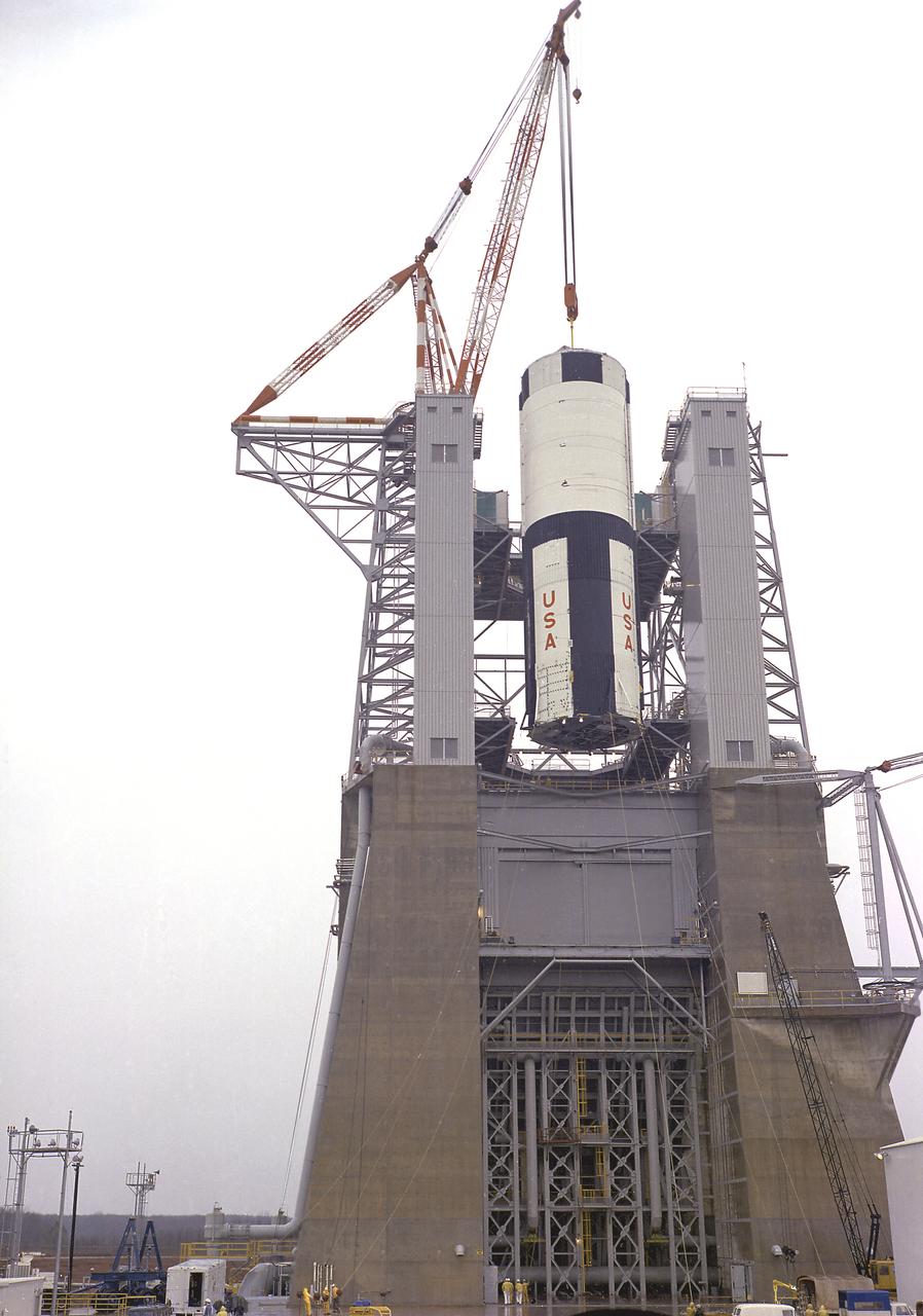 The S-IC-T stage is hoisted into the S-IC static test stand at the Marshall Space Flight Center. The S-IC-T stage is a static test vehicle not intended for flight. It was ground tested repeatedly over a period of many months proving the vehicle's propulsion system. The 280,000-pound stage, 138 feet long and 33 feet in diameter, houses the fuel and liquid oxygen tanks that hold a total of 4,400,000 pounds of liquid oxygen and kerosene. The two tanks are cornected by a 26-foot-long intertank section. Other parts of the booster included the forward skirt and the thrust structure, on which the engines were to be mounted. Five F-1 engines, each weighing 10 tons, gave the booster a total thrust of 7,500,000 pounds, roughly equivalent to 160 million horsepower. 
