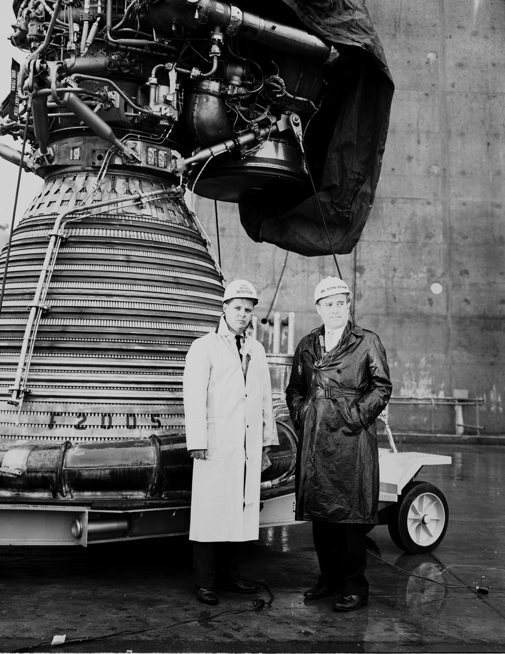 This is a photograph, probably from the early 1960s, that shows Dr. von Braun, right, with a correspondent for CBS News. The correspondent is believed to be Nelson Benton. The two men are standing in front of a huge rocket engine.