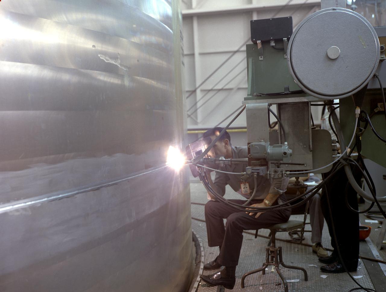 This photo shows the closeout welding operation of the liquid oxygen (LOX) tank for the Saturn V SA-501 vehicle for the Apollo 4 mission.