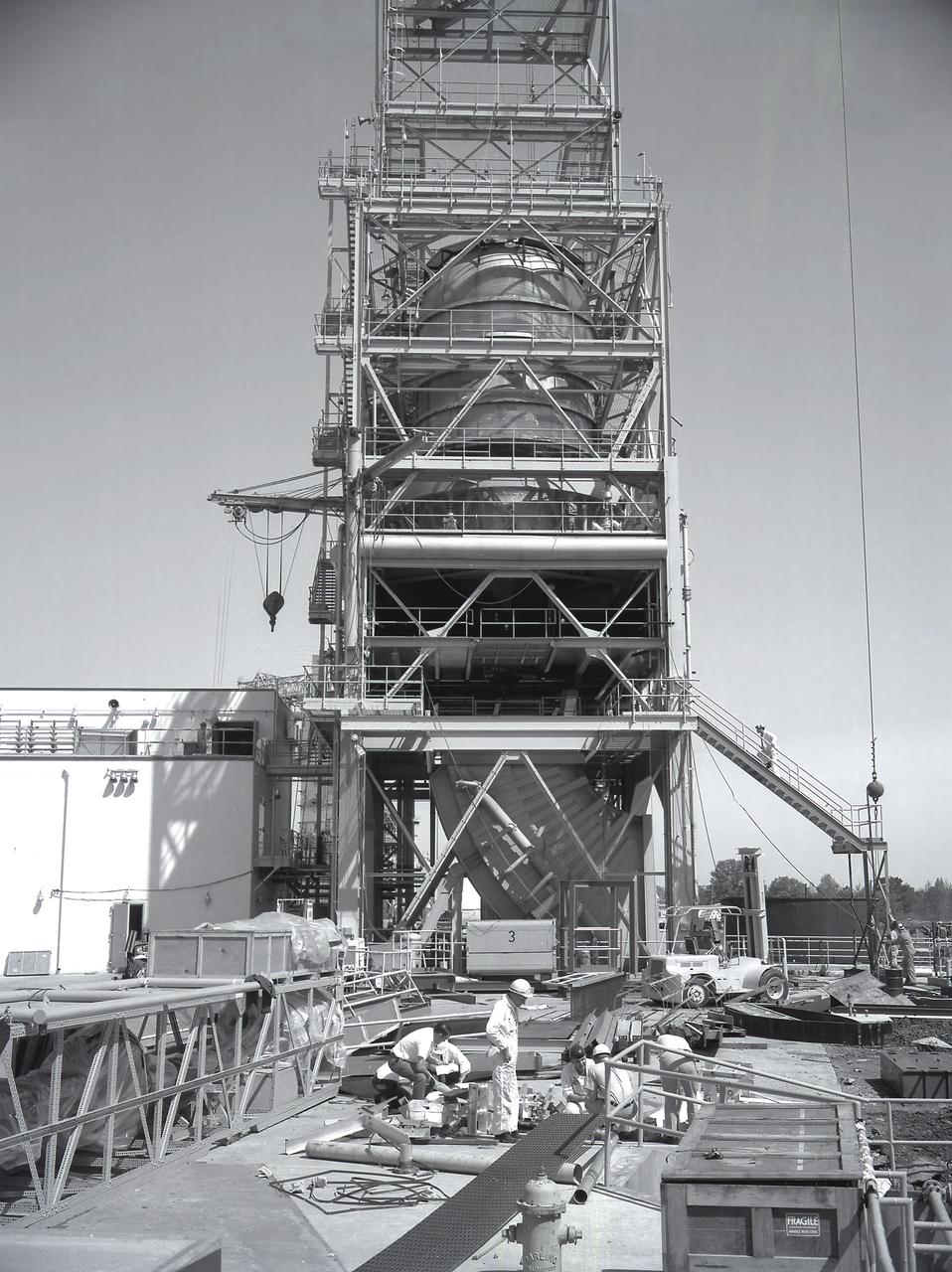 A facility test version of the S-IVB, the second stage of the Saturn IB launch vehicle, sits in the Marshall Space Flight Center (MSFC) J-2 test stand on February 10, 1965. Also known as a "battleship" because of its heavy, rugged construction, the non-flight, stainless-steel model was used to check out testing facilities at MSFC.